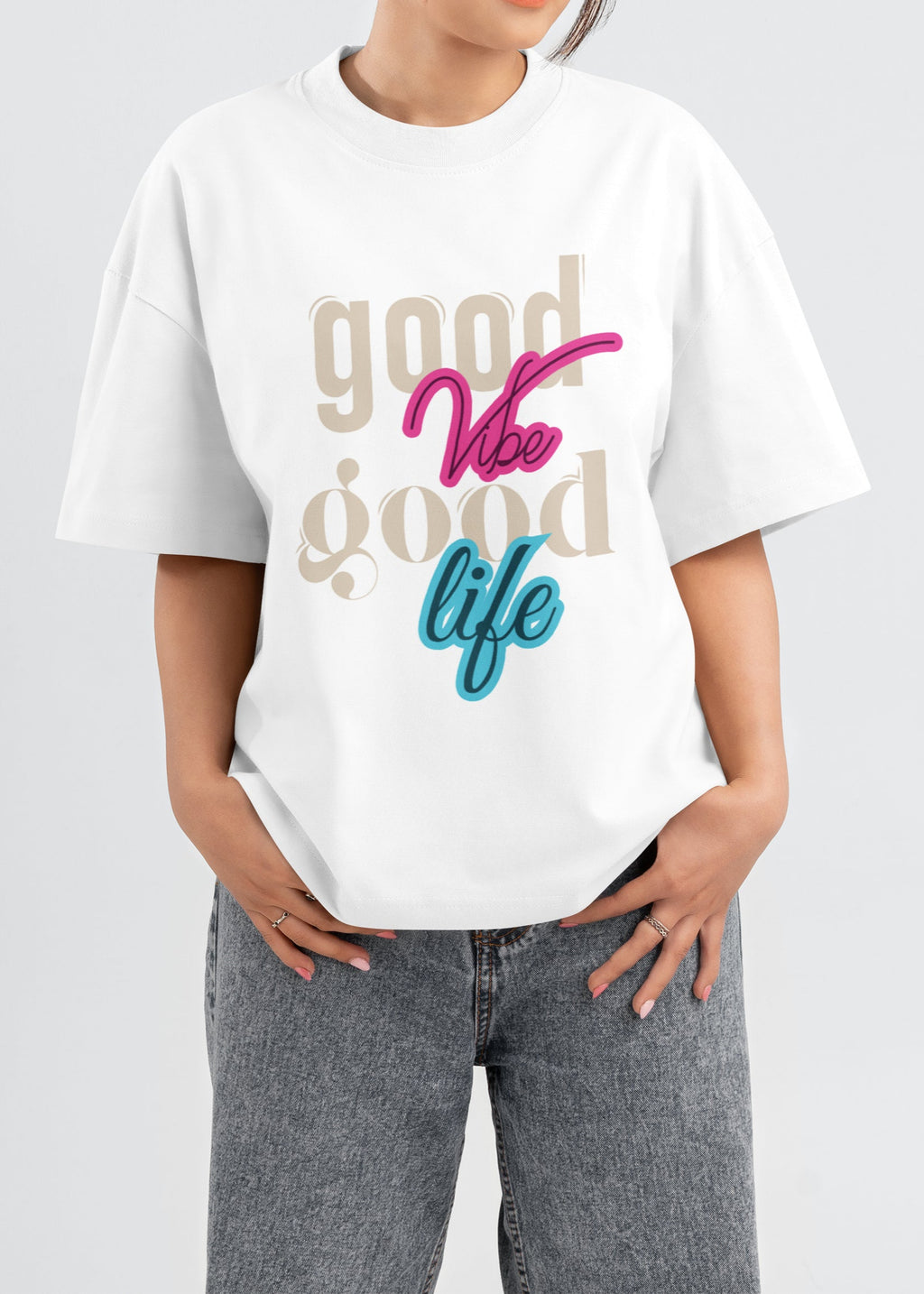 Person wearing a white t-shirt with colorful text on a plain background